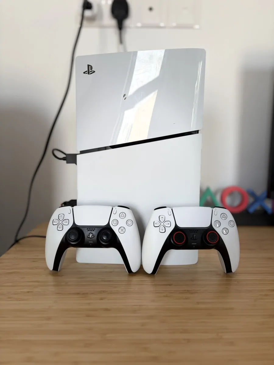 Ps5 with two controllers and a monitor